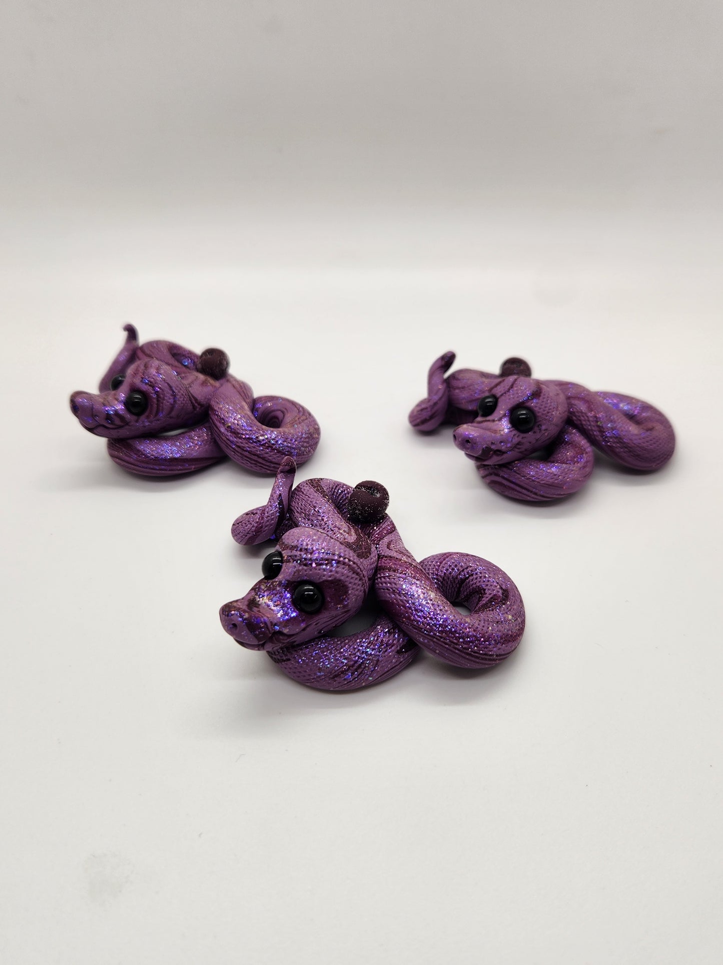 "Blomme" sugar plum snake sculpture